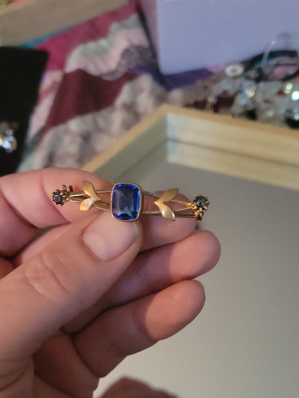 Gold-Tone Brooch with Blue Center Stone and Floral Accents